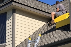 Eben McDermott using pitch hoppers to safely seal up this residence on Folly Beach